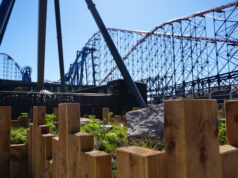 Blackpool Pleasure Beach Invites Guests to Ride AVIKTAS Early in Technical Rehearsal Event Blue-sky amusement park scene with a large blue roller coaster and red track behind wooden posts in the foreground