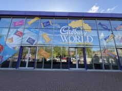 Aramark UK Officially Commences Trading at Cadbury World Glass storefront with colorful Cadbury Roses decals across the windows and a large 'Cadbury World' sign on blue-framed panels.