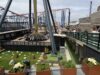 Pictures Showing AVIKTAS at Blackpool Pleasure Beach: The UK’s New Giant Swing Dominates the Skyline Amusement park ride with a circular rotating gondola around a tall central column; roller coasters visible in the background.
