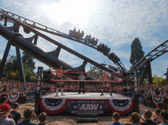 Drayton Manor’s Rock ’n’ Rumble: Wrestling, Country Music and Theme Park Thrills Two wrestlers face off inside an outdoor ring as a referee watches, with a large cheering crowd and a roller coaster in the background.
