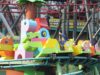 DUPLO Dino Coaster at LEGOLAND Windsor Closed for Maintenance Throughout June Colorful lego‑style roller coaster train with riders raising their hands on a bright green track.