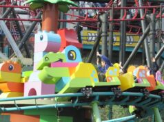DUPLO Dino Coaster at LEGOLAND Windsor Closed for Maintenance Throughout June Colorful lego‑style roller coaster train with riders raising their hands on a bright green track.