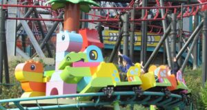 DUPLO Dino Coaster at LEGOLAND Windsor Closed for Maintenance Throughout June Colorful lego‑style roller coaster train with riders raising their hands on a bright green track.