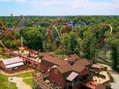 Holiday World Opens Its Gates for an Incredible 80th Season Celebration Aerial view of a forested amusement park with orange roller coasters and wooden rides interwoven among trees.