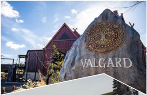 Why Valgard and Aviktas Make May 2026 a Must-Visit Month for Theme Parks Viking-themed amusement park entrance with a large carved rock and wooden buildings behind a roller coaster framework.