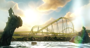 Serpent’s Curse Announced for 2027 at Paultons Park Wide fantasy landscape featuring a bright yellow roller coaster looping over rocky terrain with a dragon statue silhouette on the left and water in the foreground.