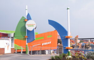 Blackpool Pleasure Beach Rides for Under 2s: What Can Toddlers Ride? Colorful Nickelodeon Land entrance with green and blue curved structures and an orange building in the background labeled Streak