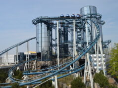 Euro-Mir to Remain Open Through 2026/27 as Europa-Park Confirms Future Farewell Blue roller coaster with riders on a high trestle, twisting around steel supports at an outdoor amusement park.
