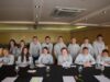 Blackpool Pleasure Beach Launches Applications for Its Junior Board of Directors 2026/27 Group of teens in grey hoodies posing around a banquet table in a restaurant or event space, smiling at the camera with glasses and papers on the table.