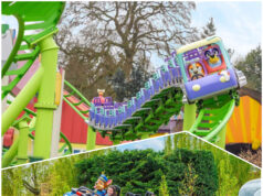 Visit the NEW World of PAW Patrol at Chessington, Then Ride NEW Bluey the Ride at Alton Towers – For FREE! Riders scream with excitement on a blue roller coaster car traveling along bright green tracks outdoors at a theme park