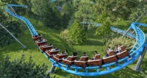 New for 2027: Eagle’s Pursuit Family Launch Coaster Announced at Waldameer Bright blue roller coaster loop with riders seated in open cars passing over a green park.