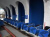 Blackpool Pleasure Beach Responds to Big Dipper Rumours Following Ride Incident Blue roller coaster cars lined up on a track inside a station with arched concrete columns and blue walls, ready for boarding.