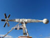 AIR Now Open at Brean Theme Park – Experience the UK’s Only Ride of Its Kind White amusement ride with a long horizontal arm ending in a globe-shaped passenger car, set on a decorative base against a clear blue sky.