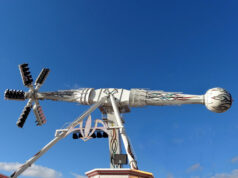 AIR Now Open at Brean Theme Park – Experience the UK’s Only Ride of Its Kind White amusement ride with a long horizontal arm ending in a globe-shaped passenger car, set on a decorative base against a clear blue sky.