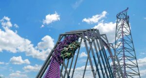 BAKUNAWA Officially Named as World’s Tallest and Fastest Spinning Launch Coaster Purple steel roller coaster cars speed down a steep drop with riders under a bright blue sky.