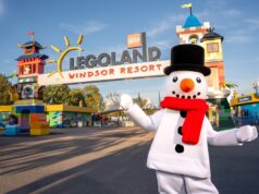 LEGOLAND Windsor Christmas 2026: Everything You Need to Know About This Magical Family Event Legoland Windsor Resort entrance with colorful towers and a snowman mascot in a black top hat and red scarf in the foreground.
