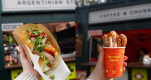 Global Cargo Eats Returns to Alton Towers for Summer 2026 Hand holding a baguette sandwich filled with greens and meat outdoors at a market stall