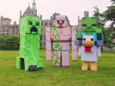 What’s Happening at UK Theme Parks This Week (Week of 13 July 2026) Three large Minecraft-style block characters stand on a grassy lawn in front of a medieval-style castle building with towers.