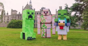 What’s Happening at UK Theme Parks This Week (Week of 13 July 2026) Three large Minecraft-style block characters stand on a grassy lawn in front of a medieval-style castle building with towers.