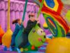 Great Yarmouth Pleasure Beach Opens Brand-New Overplay Family Adventure Today Children ride a large colorful knitted dragon sculpture in a bouncy play area, grabbing green ropes and smiling.