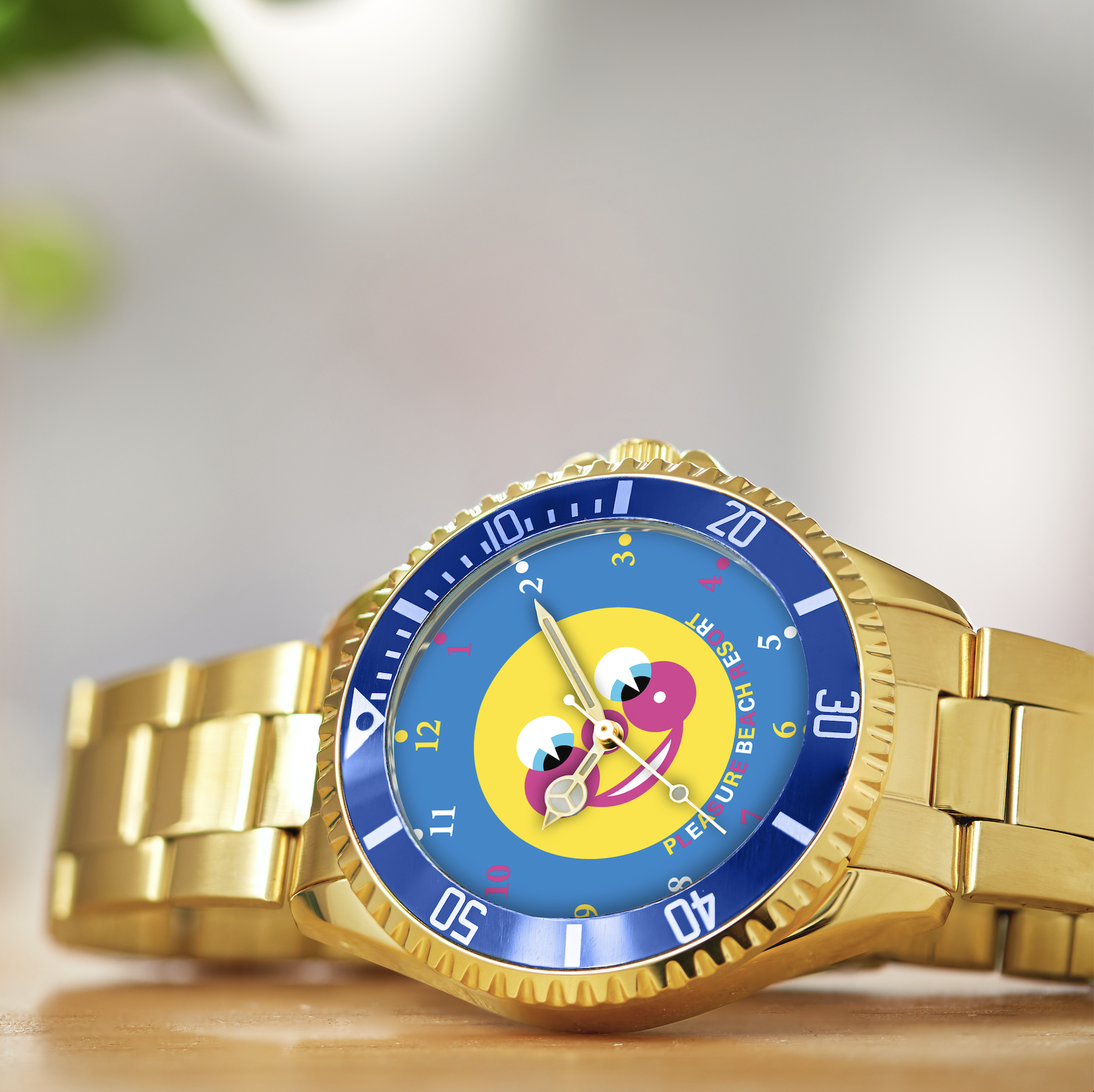 Pleasure Beach Resort Slashes Collectors Watch Prices by 50% in Limited-Time Sale Close-up of a gold wristwatch with a blue bezel and a colorful cartoon dial featuring yellow and pink shapes.