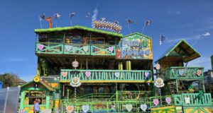 Dreamland Margate Welcomes Bavarian-Themed Funhouse to its 2026 Summer Ride Line-Up Colorful, multi-level carnival fun house with Bavarian-themed signage and decorative hearts, set on a trailer.
