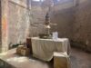 Step Back in Time: Photos from the New Alton Towers Exhibition Industrial art installation: a ship-shaped pedestal with a wire globe above, displayed on a table in a stone-walled room.