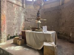 Step Back in Time: Photos from the New Alton Towers Exhibition Industrial art installation: a ship-shaped pedestal with a wire globe above, displayed on a table in a stone-walled room.