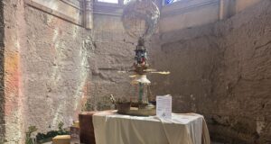 Step Back in Time: Photos from the New Alton Towers Exhibition Industrial art installation: a ship-shaped pedestal with a wire globe above, displayed on a table in a stone-walled room.