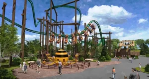 Six Flags Great America Announces Camp Timber Trail, An All-New Family Adventure for 2027 Bee-themed playground with elevated green track, wooden beams, and children riding bee-shaped cars around a large striped bee centerpiece.